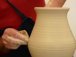 CU TU Shot of female potter shapes pitcher on potterwheel at pottery / Landshut, Bavaria, Germany Stock Footage