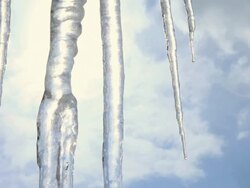 CU Water dripping from icicle against blue sky / Rausu, Japan Stock Footage