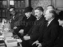 1950: BEAULIEU: DORDOGNE VALLEY:  VS Males entering 'E.J. Gourinchas' notary building. INT VS Male notary lighting small candle, males bidding (for property), candles goes out, one male standing up to claim bid. Auction, France, country, rural Instructional Video