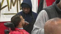 Men having haircuts in a barber shop News Clip