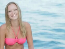 Ð¡heerful young woman flirting, showing her hair on sea background Stock Footage