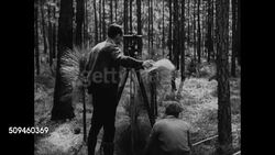 1937: PINE FORESTS: INT Southern pine tree forest. MS Behind surveyors taking measurement in pine forest, WS Surveyors measuring. VS Men w/ notepads, appraisers making notes in pine forest.  New, emerging market, Great Depression, cash crop. Instructional Video