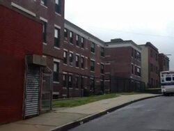 Toddler dies after fall from Dorchester apartment building Stock Footage