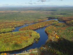 WS ARIEAL View of Meandering Penobscot river with wooded area and autumn color / Maine, United States Stock Footage