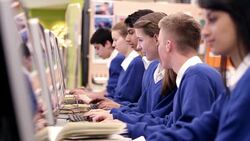 Students talking and studying in school computer lab Stock Footage