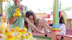 Children winning prize at amusement park Stock Footage