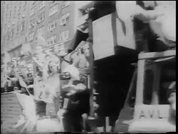 B/W 1967 crowd waving American flags on truck passing camera / pro-Vietnam War parade Stock Footage