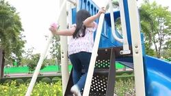 Cute girl is playing and enjoy at amusement park Stock Footage