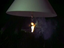 SLOMO MCU light bulb under shade exploding Stock Footage