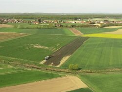 AERIAL Farmer spreading the liquid manure over a field Stock Footage