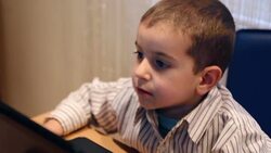 Little boy typing on laptop Stock Footage