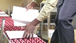 Man working at printers packing catalogs Stock Footage