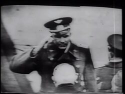 B/W 1961 high angle Yuri Gagarin saluting then kissing + hugging Nikita Khrushchev after flight / on TV Stock Footage