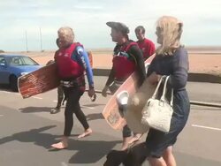 Richard Branson and Sam Branson walk up the beach Stock Footage