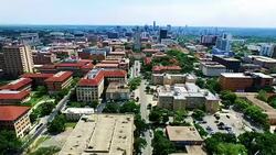 High Contrast Far Away shot with UT Tower and skyline in the distance Aerial Fly by Austin Texas Over University of Texas Stock Footage