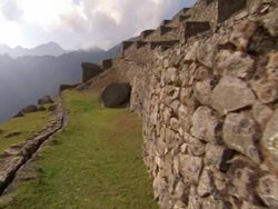 Scenic shots of the Inca rock wall structures of Machu Picchu. Shot of a steep cliff, leading down to the Urubamba River. Stock Footage