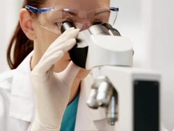 Female Scientist Working With Microscope Stock Footage