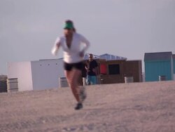 Runners running along Miami Beach News Clip