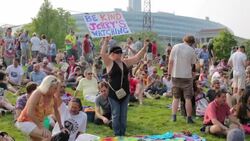Grateful Dead 50th Anniversary Fare Thee Well concert Woman Holding sign reading, 'Jerry is watching,' July 4, 2015 Stock Footage