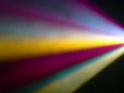 Rainbow light beams from a prism on black background Stock Footage
