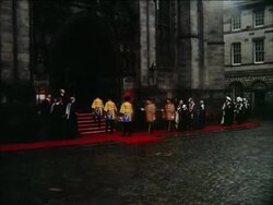Queen Elizabeth II and Duke of Edinburgh head procession of Knights of the Thistle, Scotlands highest order of chivalry, to St Giles Cathedral, Scotland, UK Stock Footage