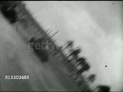 1942: FORT JACKSON REVIEW: BEHIND cameraman filming British Prime Minister Winston Churchill walking away from mics. VS FALLEN CAMERA FILMING ground, sky, MS Unidentified US Army soldier w/ Pullman railroad car BG. Home Movies, WWII, training camp Instructional Video