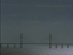 WA Severn Bridge with sunlight glittering off Severn Estuary, England Stock Footage
