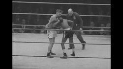 Black boxer and white boxer compete in boxing match in late 1930s/early 1940s News Clip