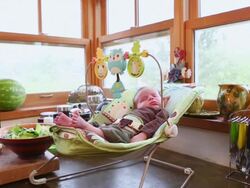 MS PAN Shot of baby sleeping in bouncy chair while mother preparing meal / Lamy, New Mexico, United States Stock Footage