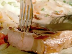 ECU steak knife cuts into sirloin steak while fork pivots slice away from steak to show medium rare state of cooked meat Stock Footage