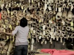 Fashion design looking at rolled up patterns Stock Footage