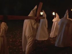 RECREATION KKK members in white gowns carrying a large, wooden cross and burning torches / Rockford, Illinois, United States Stock Footage