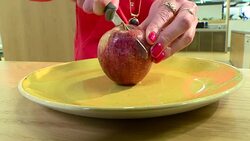 Anonymous shot of a woman cutting an apple in half News Clip
