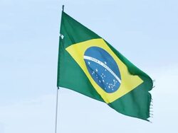 MS Shot of brazilian flag at beach moving on wind / Rio de Janeiro, Brazil  Stock Footage