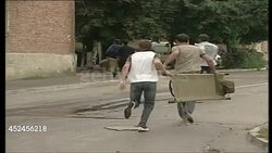 Locals Carrying Stretchers Outside Beslan School News Clip