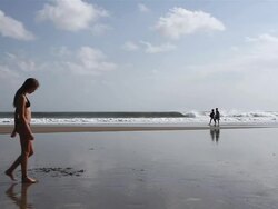 MS Teenage girl walking on along beach / Seminyak, Bali, Indonesia Stock Footage