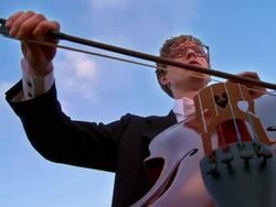 CRANE: Man Playing Cello Outdoors Stock Footage