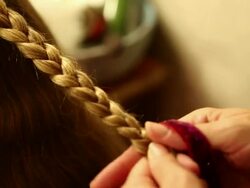 CU Mother braiding her daughter's hair / St. Simon's Island, Georgia, United States Stock Footage