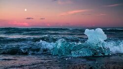 Ice on ice beach with water wave in Jokulsarlon, Iceland Stock Footage