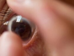 Woman inserting Contact Lens Stock Footage