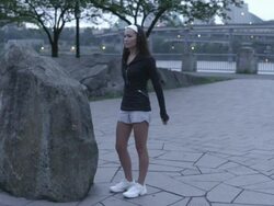 MS Shot of young woman stretches and prepares for her morning jog before dawn on city water front / Portland, Oregon, United States  Stock Footage