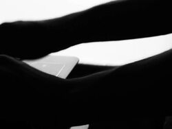 Dolly shot:Typing fingers push white notebook Silhouette Stock Footage