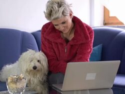 HD DOLLY: Woman And Her Dog Using A Laptop Stock Footage