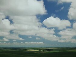Time lapse blue sky clouds over green fields Stock Footage