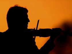HD: Silhouette Of A Violinist At Sunset Stock Footage