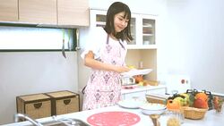 Young Japanese woman working at a kitchen Stock Footage