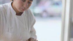 Pastry chef flattens dough with rolling pin in restaurant window Stock Footage