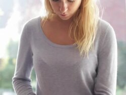 Female in kitchen preparing food and look at ipad Stock Footage