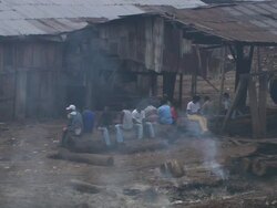 WS View of desolated land with men resting with smoke / Lagos, Nigeria Stock Footage
