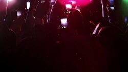 Crowd waving arms holding cell phones at concert Stock Footage